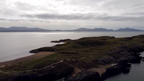 aerial view ynys llanddwyn island anglesey coastal trail with snowdonia mountains across the irish sea