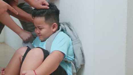 young asian students slapping little boy demonstrating disrespect, cruelty. bullying, discrimination and racism concept