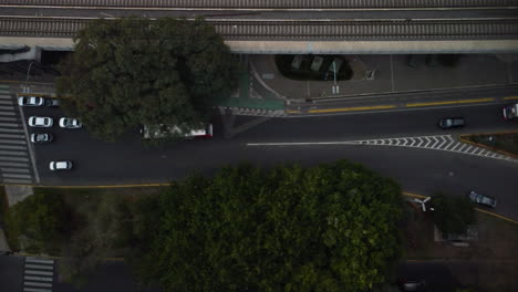 Cars-pile-up-in-front-of-a-pedestrian-crossing,-pedestrians-cross-the-road,-a-truck-drives-along-the-road-and-queues-up-for-cars,-top-view