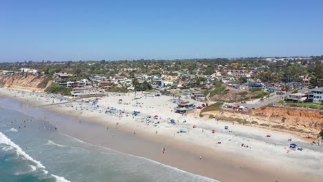aerial view of a busy and crowded beach at summer in california, america