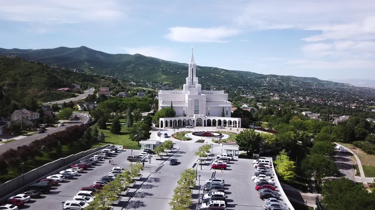 Drone Shot slowly and smoothly approaching the Bountiful Temple on a Sunny Day. The temple is owned and operated by the Church of Jesus Christ of Latter Day Saints.