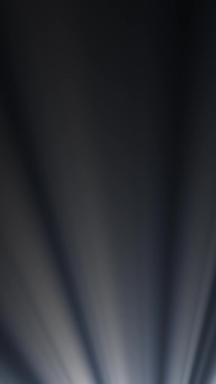 Abstract Light Rays Moving and Fading on a Dark Background