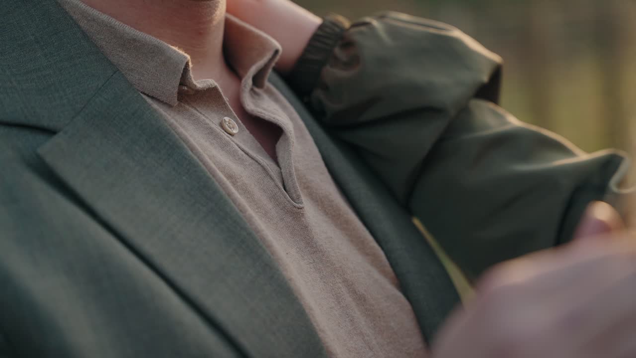 Close up of tender embrace with hand placed on shoulder in soft light