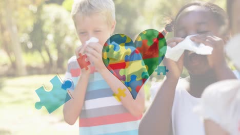 Animation-of-colourful-puzzle-pieces-heart-over-children-blowing-their-noses