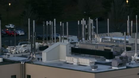 Long-aerial-zoom-of-steel-smoke-stacks-on-industrial-laboratory-building-in-America