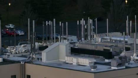 long aerial zoom of steel smoke stacks on industrial laboratory building in america
