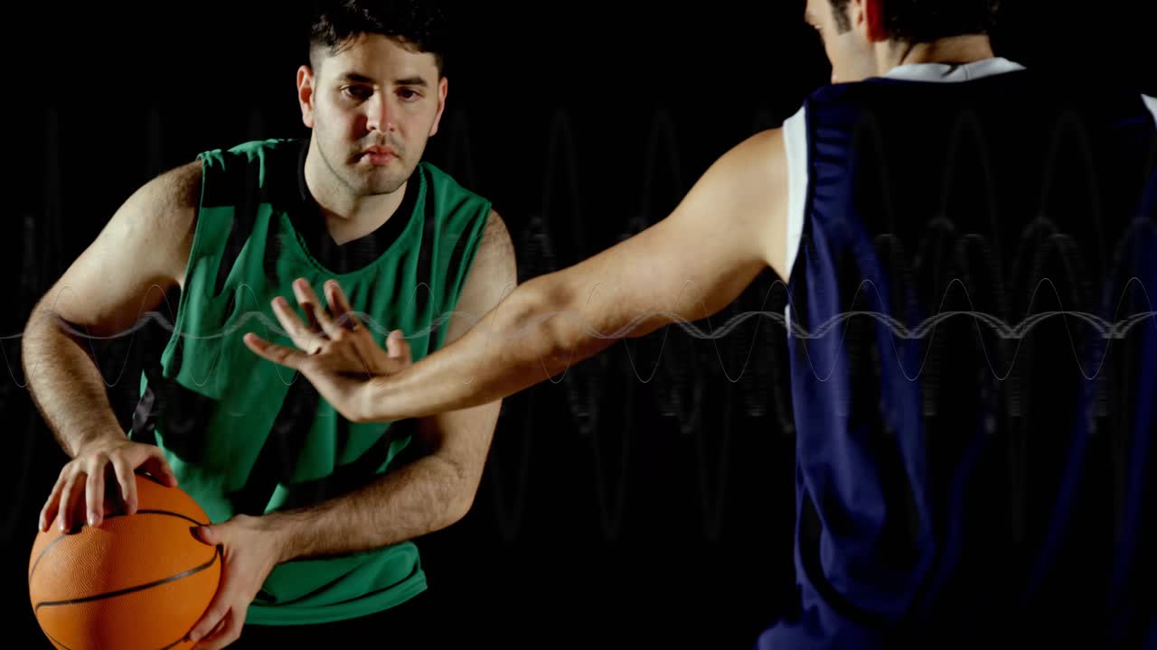 Defender pressing shooter by extending arm, shooter firing basketball jump shot for scoring