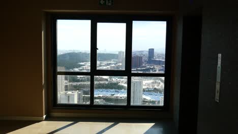 high-rise apartment hallway with city view