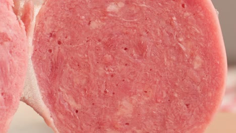 ham italian mordatella, man slices of traditional italian antipasti mortadella sausage on a wooden cutting board, close up macro of chicken or turkey jamon, fat breakfast dish.