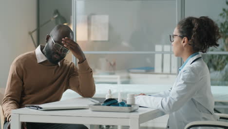 african american man having medical consultation with female doctor