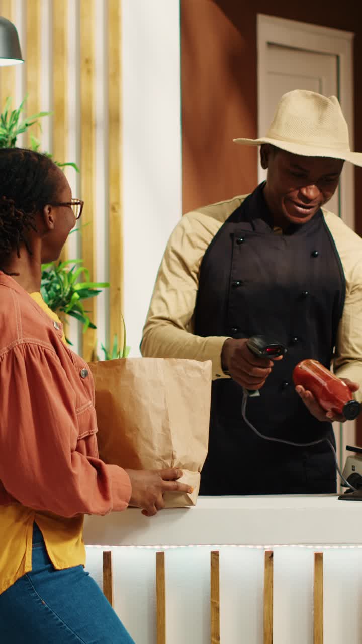 Vertical Video Vegan client giving products to vendor at cash register to scan
