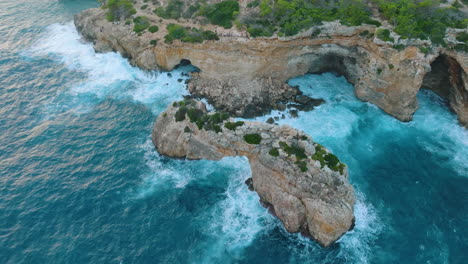 coastal cliffs with caves and rocky arch