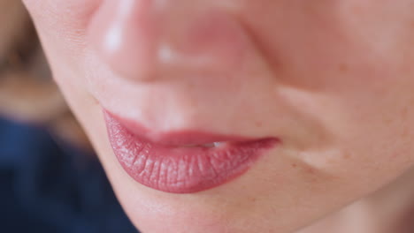 high angle view of wellness guide lips and lower face moving gently in calm conversation with client, blurred background offering soft, serene atmosphere in intimate coaching