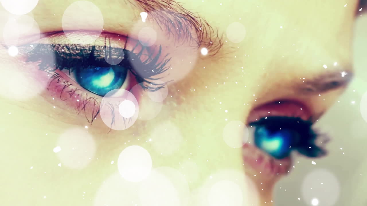 Animation of eyes with blue reflections and abstract light bokeh effects