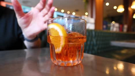 man drinking a lemon beverage in a cafe