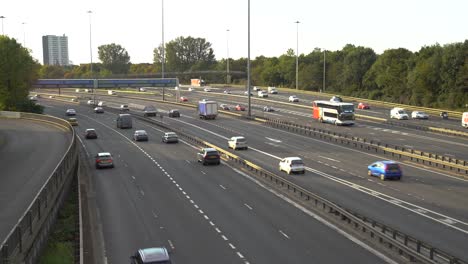 vehicles driving on a motorway on highway m8 of the ring of glasgow on a bright summer day