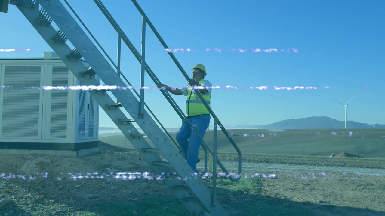 Construction worker climbing steel stairway on renewable energy site, showing animated data charts