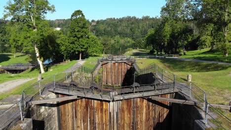 aerial rising out of old lock chamber with large wooden gate in front