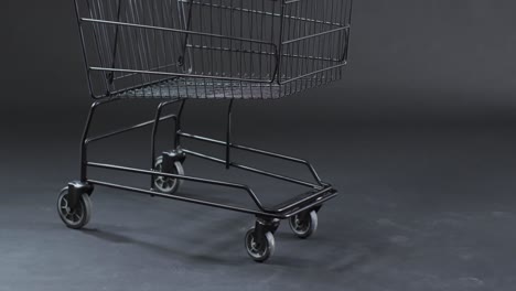 Video-of-shopping-trolley-with-copy-space-over-grey-background