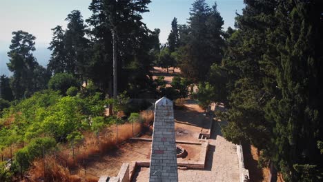 stone monument in a forested park on a sunny day