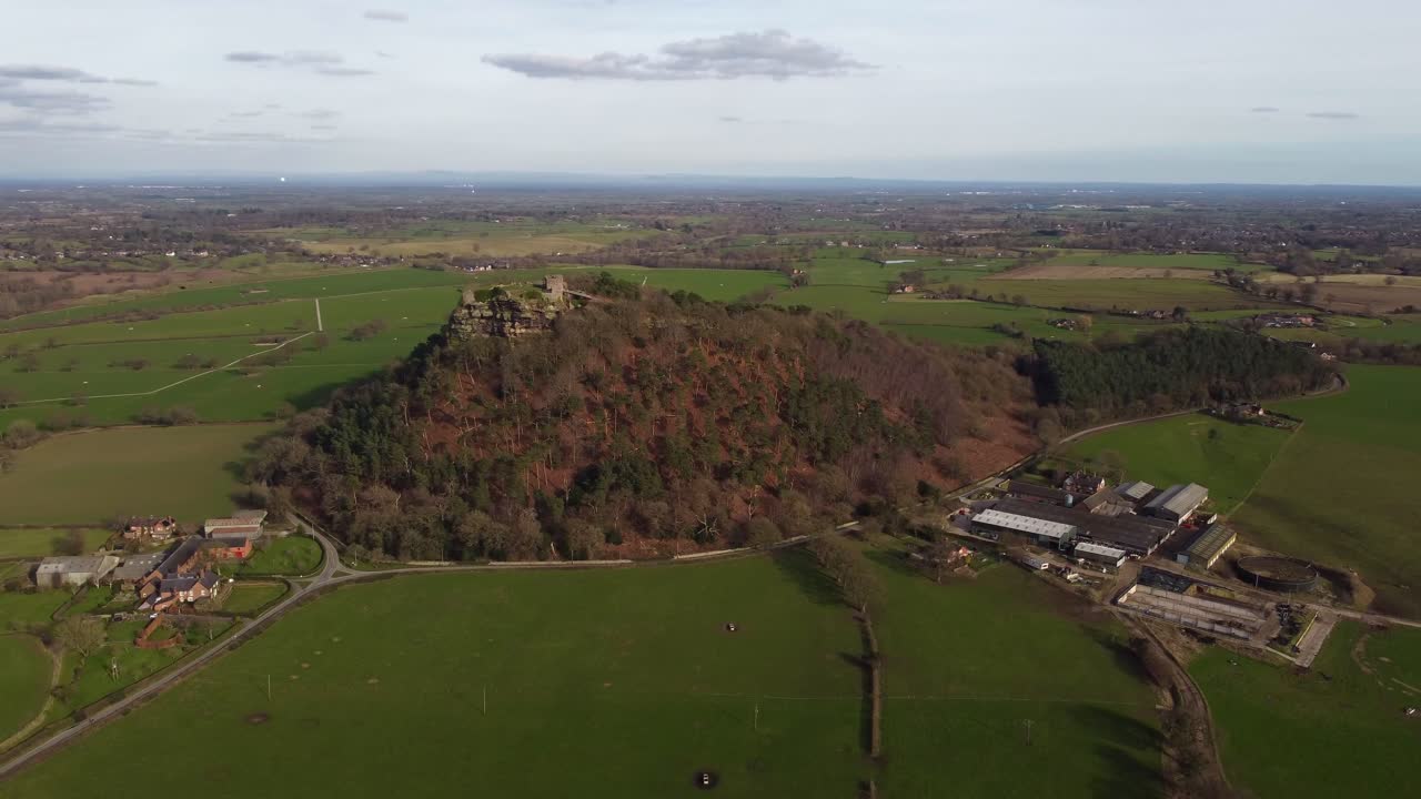 Drone slowly circling English Heritage site Beeston Castle on Beeston Crag - Cheshire, England, UK