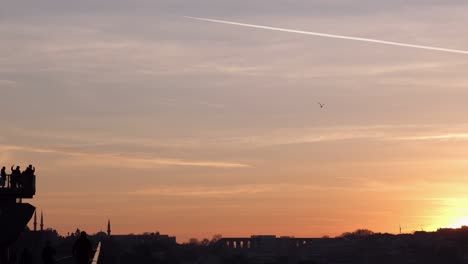 minimalist sunset sky with selfie taking people at istanbul subway bridge