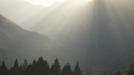 Sunset-run-says-through-the-mountains-in-Benasque-Mountain,-Spain,-wide-tilt-up