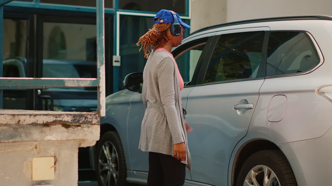 Woman getting out of car with food delivery bag