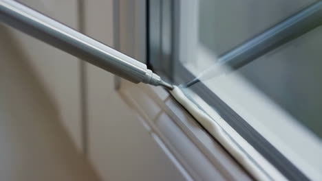applying sealant to a window frame