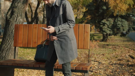 businessman using phone in park