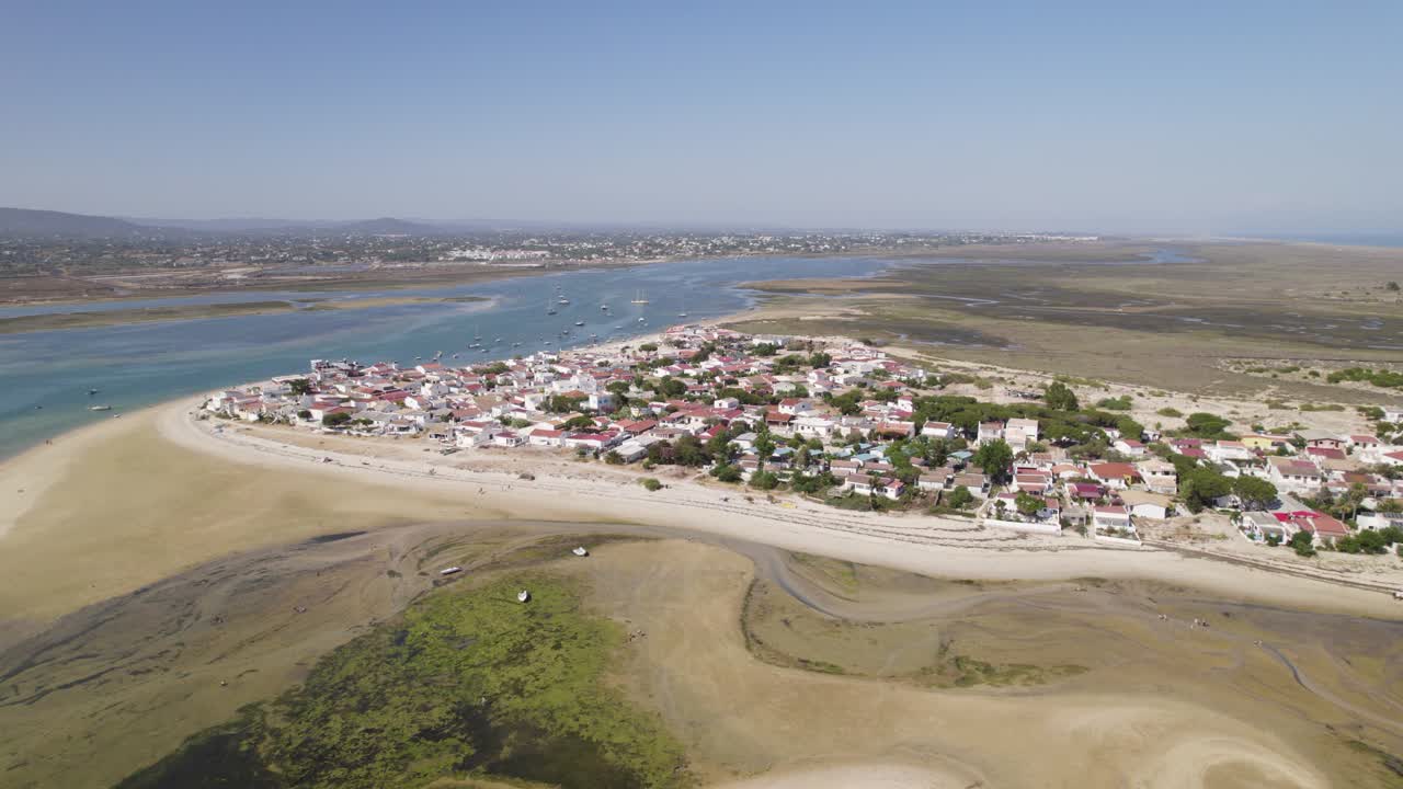 la isla de armona y la costa de olhão en portugal bajo un cielo azul claro, vista aérea