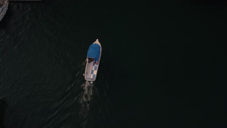 Overhead-shot-of-fishing-boat-coming-back-to-port-of-Milna,-Brac-Island,-Croatia