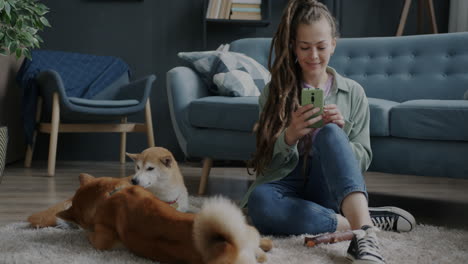woman interacting with dogs at home