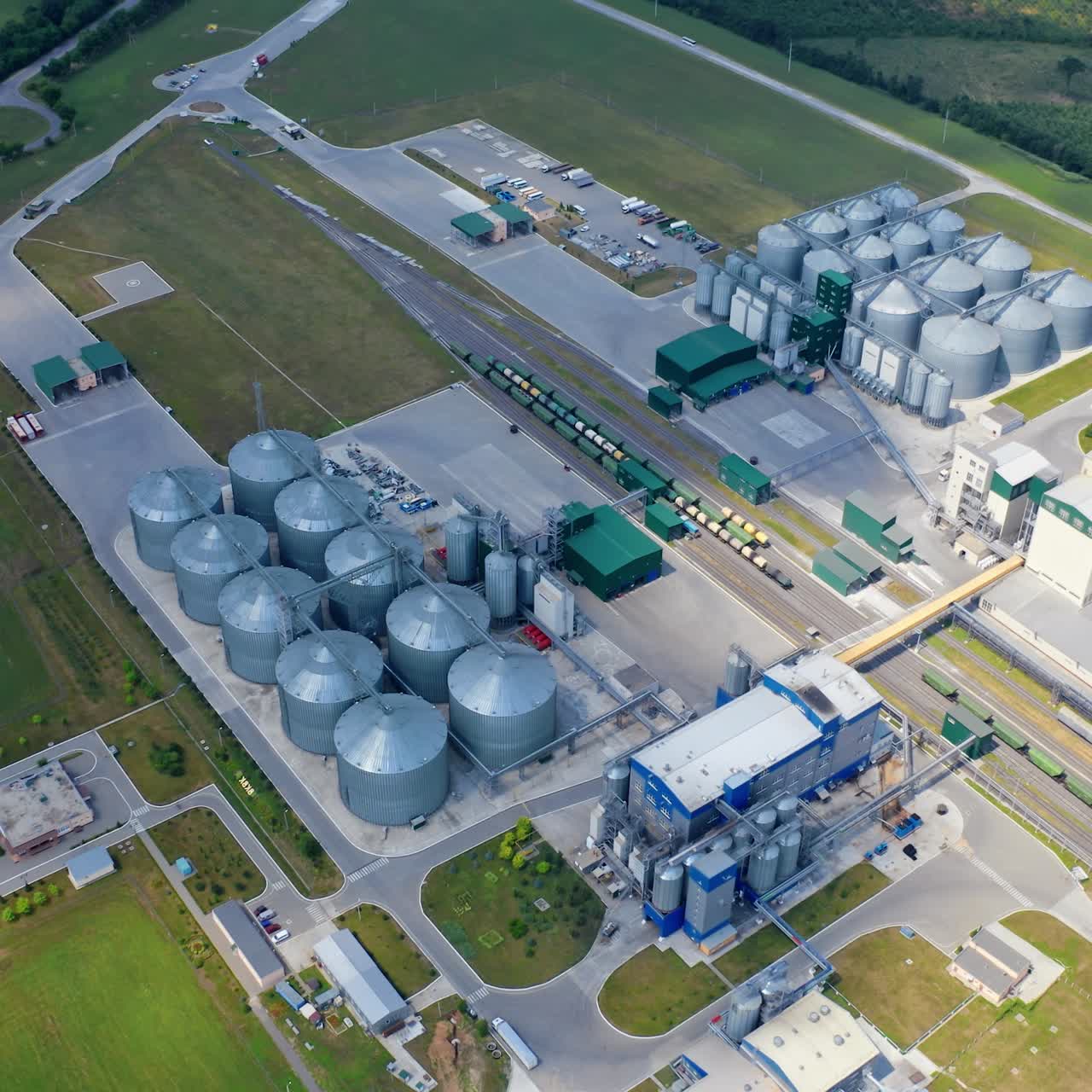 Tower industrial metal grain elevator storages. Big factory steel factory storages