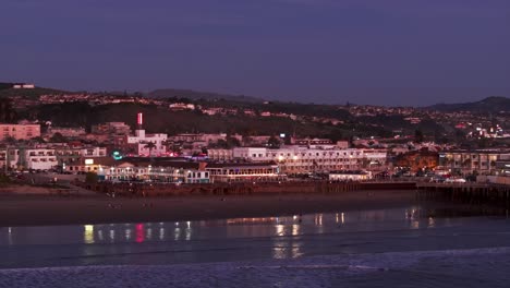 sunset-drone-aerial-view-over-pismo-beach,-california-during-sunset