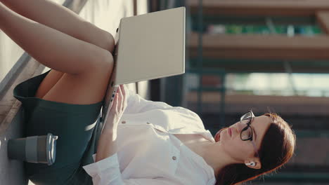 woman working on laptop outdoors