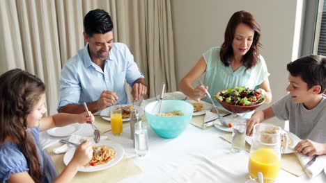 happy family having a spaghetti dinner together