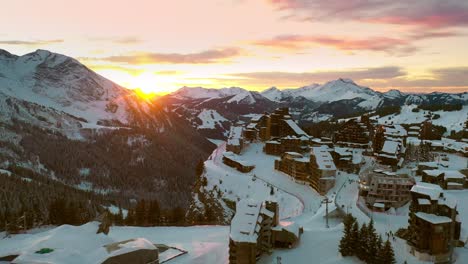 dramatic sunset over mountain ski resort village, avoriaz aerial view