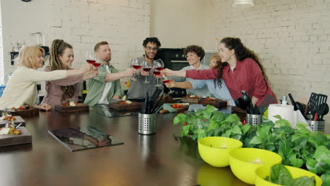 friends celebrating with wine in a kitchen