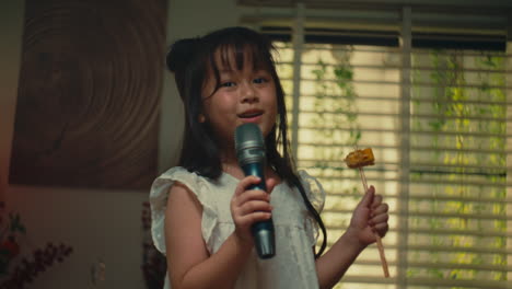 Little Girl Singing and Eating