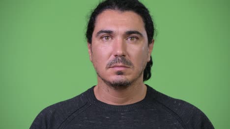 happy handsome man against green background