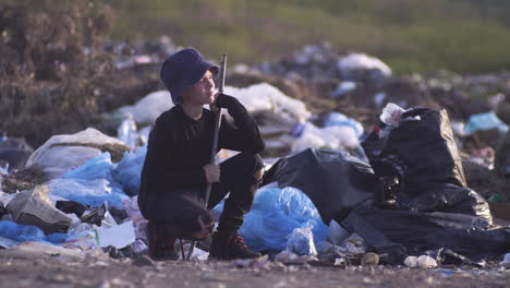young person in a landfill
