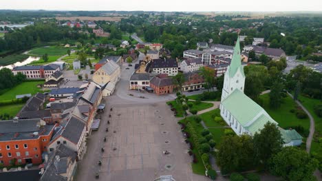 aerial panorama of dobele town center and evangelical lutheran church at summer scenic drone view in golden hour light over dobeles historic center on a warm summer evening peaceful latvian town