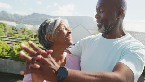 video of relaxing senior african american couple dancing in the garden