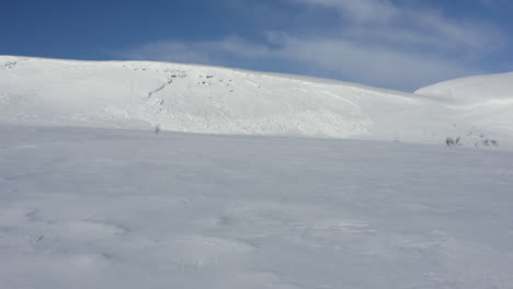 aerial view of a small snow avalanche in the mountains in the northern sweden