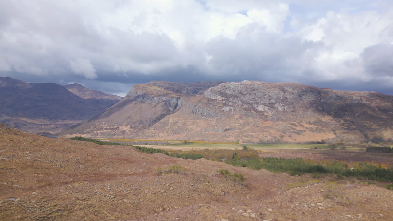 Scenic view of Beinn Eighe mountains in Scotland under a cloudy sky