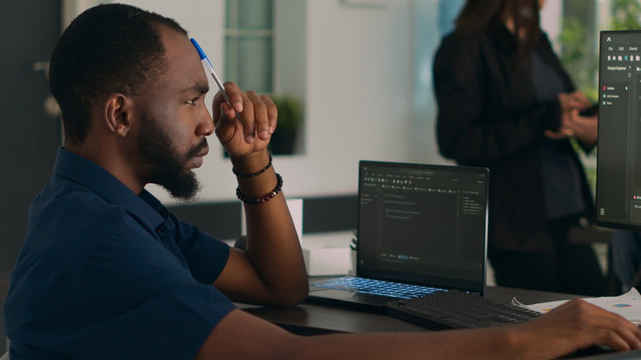Software developer brainstorming ideas to write code and create new interface