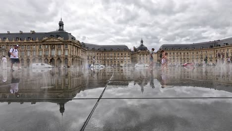 visitors interact with water mirror in bordeaux