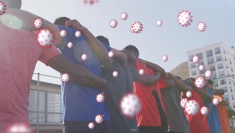 animation of virus cells floating over diverse group of male football players embracing