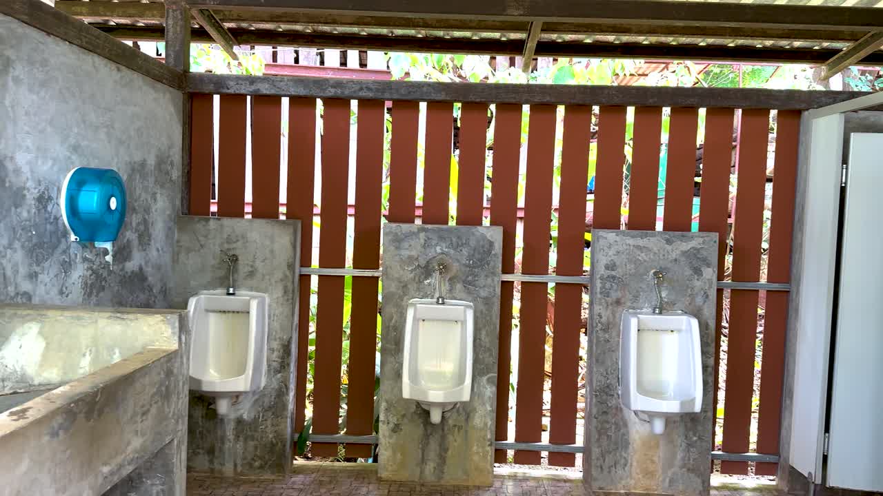 Empty male restroom with urinals and sink